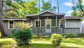 A single-story house with a porch, a front door, and a small window. - Cozy, Well-Appointed Cottage By Blue Ridge Parkway (Asheville)