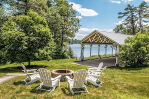A gazebo with a view of a lake, surrounded by trees and a grassy area with Adirondack chairs. - RoseWood Landing (Silver Lake)