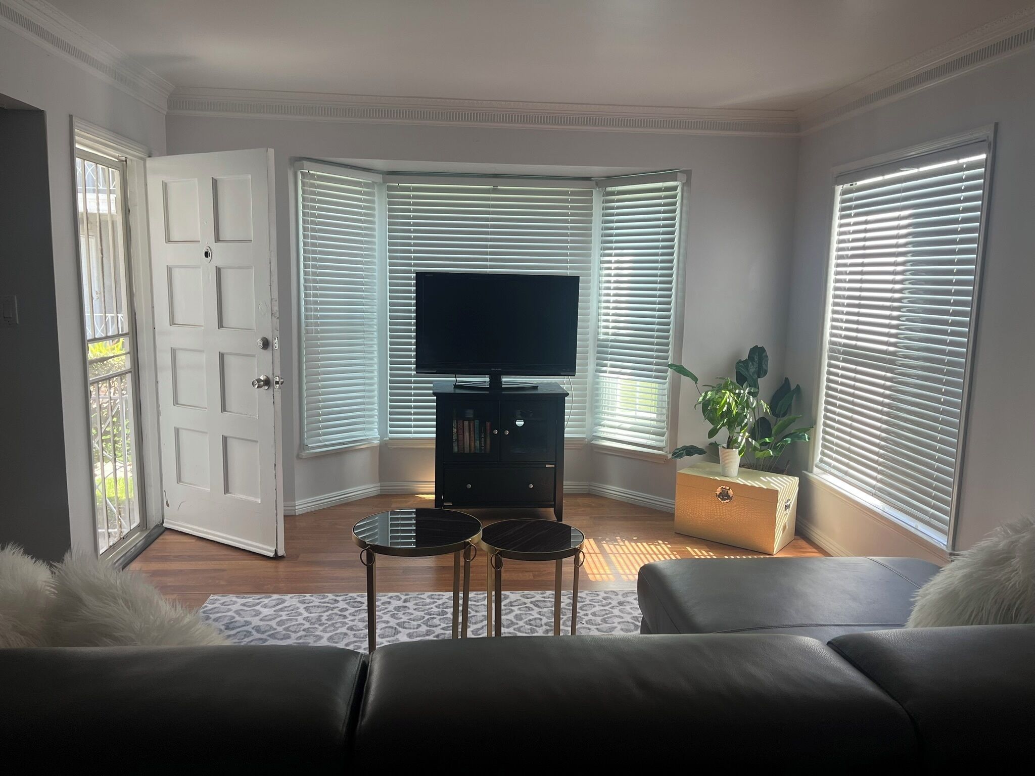 A living room with a television, a small table, and a sofa.