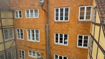 A traditional European building with multiple windows and a brick facade.