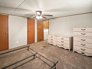 A room with a ceiling fan, wooden doors, a kitchenette, and a dresser with drawers. - 2-bedroom mobile home with a sleeping sofa in peaceful Mammoth Cave with AC. (Mammoth Cave)