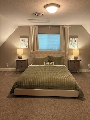 A bedroom with a large bed, two bedside tables, a ceiling light, and a window with curtains. - The Windsor Exchange Retreat (Windsor)