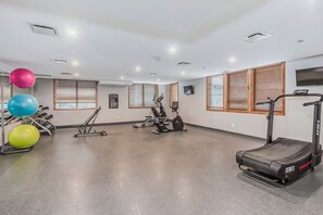 A gym with treadmills, stationary bikes, and exercise balls. - Spring Creek Getaway, Luxury 1BR Condo in Canmore (Canmore)