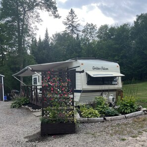 A recreational vehicle named 'Golden Falcon' with a covered porch and a garden area with various plants. - Mag River Paradise
Paddle • Fish • Swim • Relax
Experience the Magnetawan
River (Burk's Falls)