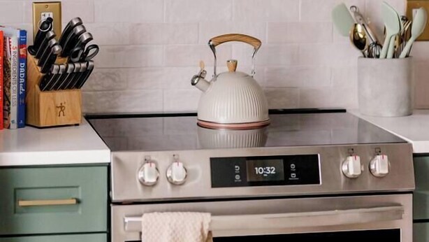 A kitchen with a stainless steel microwave, a stove, and a kettle. - Retro Luxe Suite, Downtown Manchester near Hartford Sleeps 4! New! (Manchester)