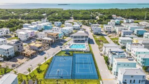 A residential area with modern houses, a swimming pool, and a basketball court.