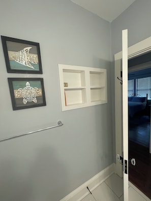 A bathroom with a towel rack, a framed fish and turtle artwork, and a white medicine cabinet. - Fabulous 3-bedroom house with AC in charming Rome (Rome)