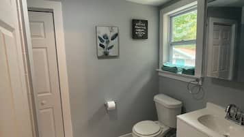 Shower, hair dryer, towels, toilet paper