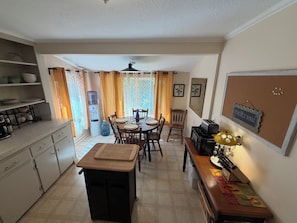 A compact kitchen with a dining area, a water dispenser, and a vintage toaster. - Cozy home minutes from SU campus, area hospitals & all major highways. (Syracuse)