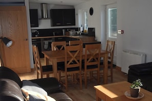 A compact living space with a kitchen, dining area, and seating area.