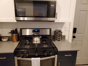A kitchen with a stove, microwave, oven, and a kettle. - Delightful Home with W&D and Office in Salt Lake City (Salt Lake City)