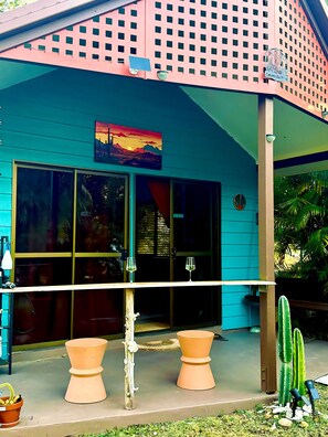 A building with a blue exterior, a large window, and a sign that reads 'Cabana De Playa'.