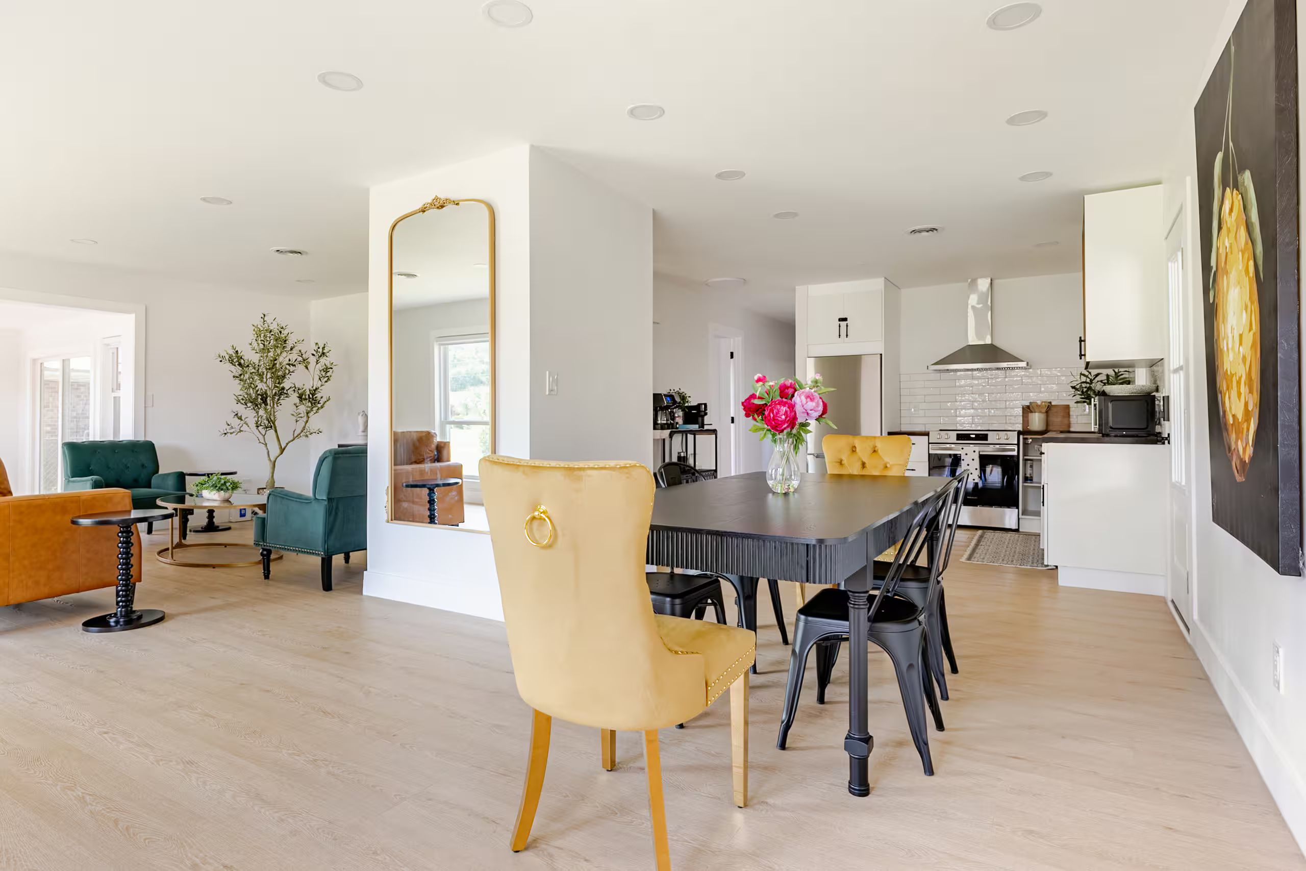 A modern interior with a dining area, kitchen, and living space.