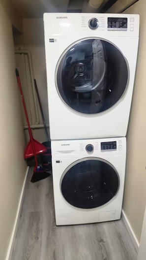 A stacked washer and dryer unit in a laundry room.