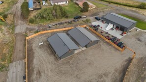 A large industrial building with multiple sections, surrounded by a fenced area. - Family Lodge/Sleeps 10 + Hot Tub (Saint Anthony)