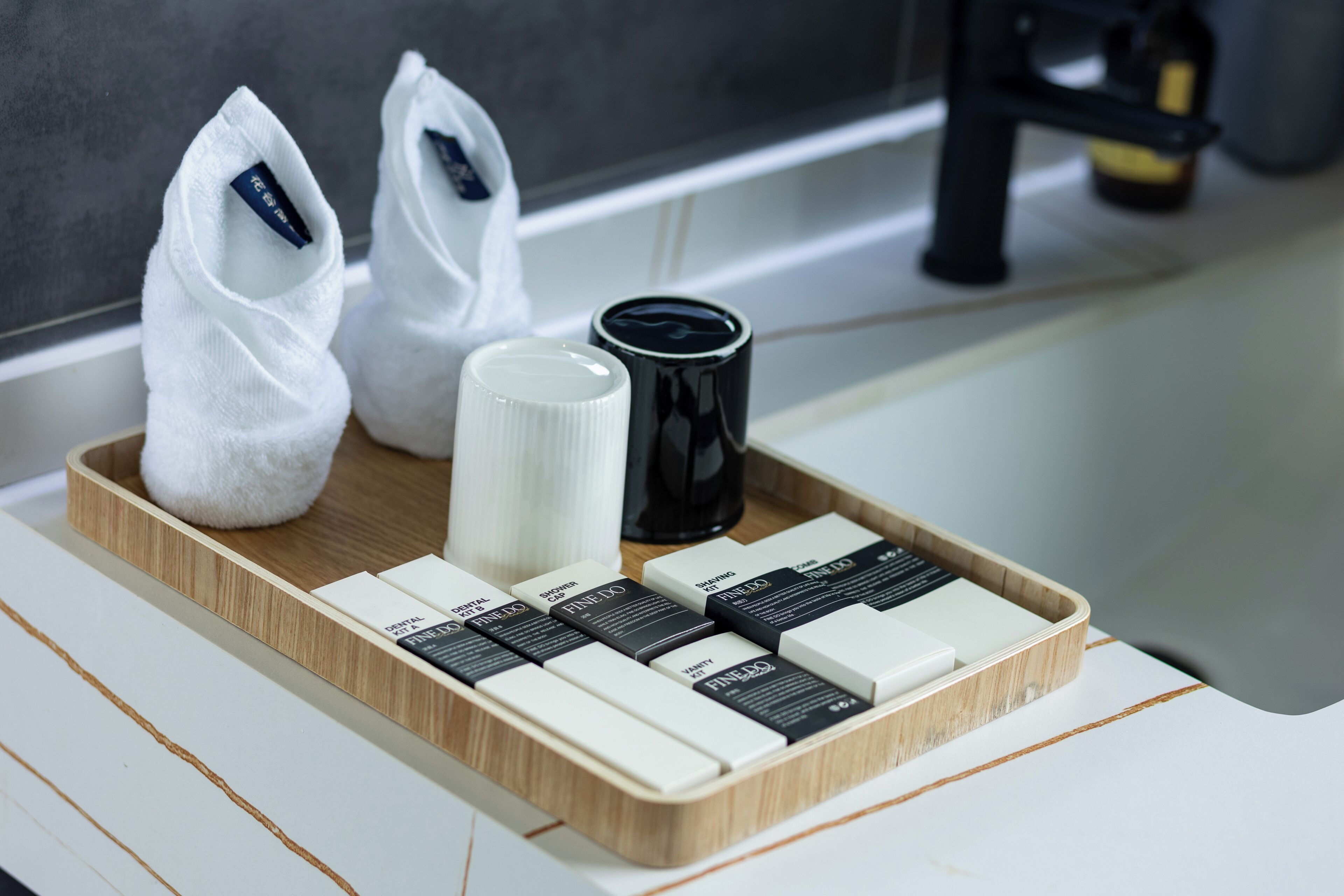 A tray with various toiletries including a toothbrush, toothpaste, and a cup.