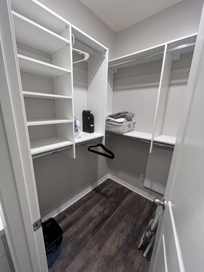 A walk-in closet with open shelving, a hanging rod, and a small storage bin. - Charming 2-bedroom townhome in Imperial Beach, close to Coronado (Imperial Beach)