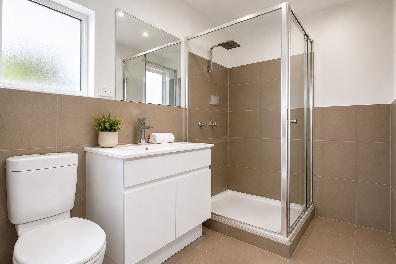 A modern bathroom with a toilet, sink, and shower.