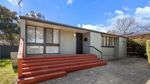 A modern two-story house with a front porch and a brick driveway. - Family-Friendly 3-Bed House in Kambah (Kambah)
