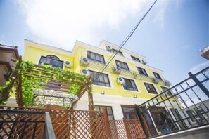 A multi-story building with balconies, a visible staircase, and a clear sky. - Shengsi Blue Bank Bieguan Homestay (Shengsi)