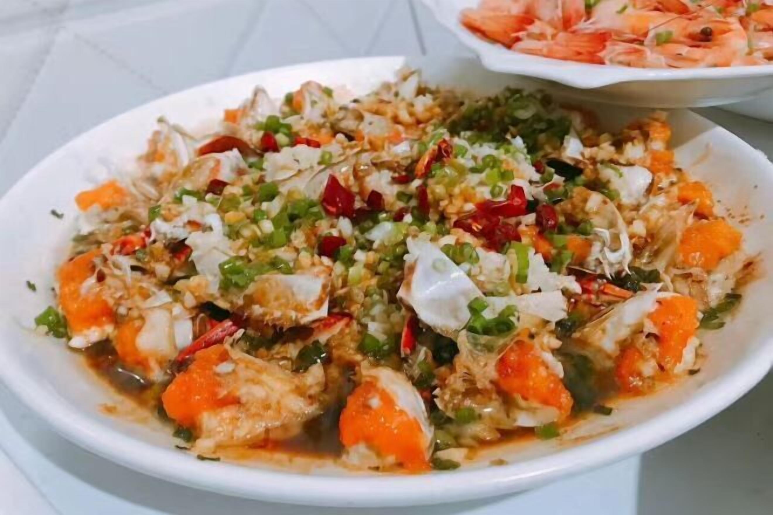 A dish with seafood, vegetables, and a creamy sauce.