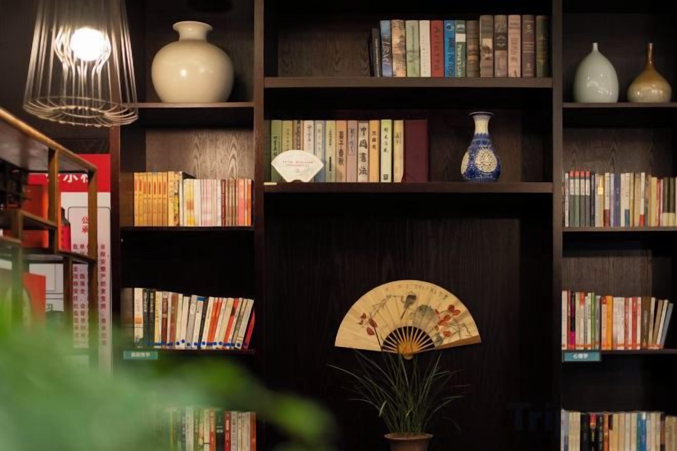 A bookshelf with books and decorative items.