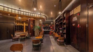 A spacious lobby with multiple seating areas, a bar, and a reception desk.