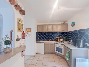 A compact kitchen with a gas stove, oven, and a sink. - La Jeansarde by Interhome (Fox-Amphoux)