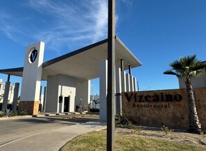 A modern building with a prominent entrance and a sign that reads 'Vizcaino Residencial.' - Ocean View + Hot Tub + EV Charger@ Poseidón Villa (B.C.)