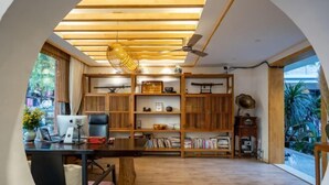 A modern interior with a wooden desk, bookshelves, and a ceiling fan. - Youdu Inn (Dali City)