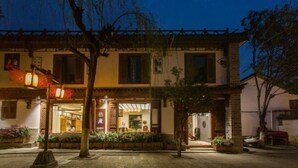 A traditional building with a courtyard, a restaurant entrance, and a visible sign. - Youdu Inn (Dali City)