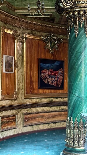 A room with ornate wood paneling, a marble floor, and a painting of fruits. - Alexandrapol Hotel Palace (Gyumri)