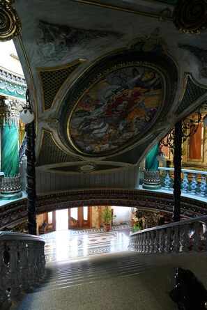 An ornate interior with a detailed ceiling mural, a grand staircase, and classical architectural elements. - Alexandrapol Hotel Palace (Gyumri)