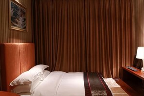 A hotel room with a large bed, a headboard, a nightstand, and a curtain. - Xiushan Yaxi Hotel (Xiushan Railway Station) (Xiushan County)