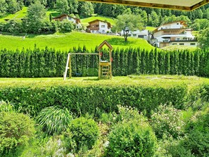 A residential area with houses on a hillside, a playground, and a neatly trimmed hedge. - Apart Nachtigall by Interhome (Arzl im Pitztal)