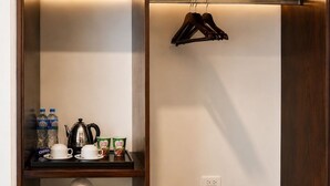 A walk-in closet with shelves, a hanging rack, and a shoe rack.