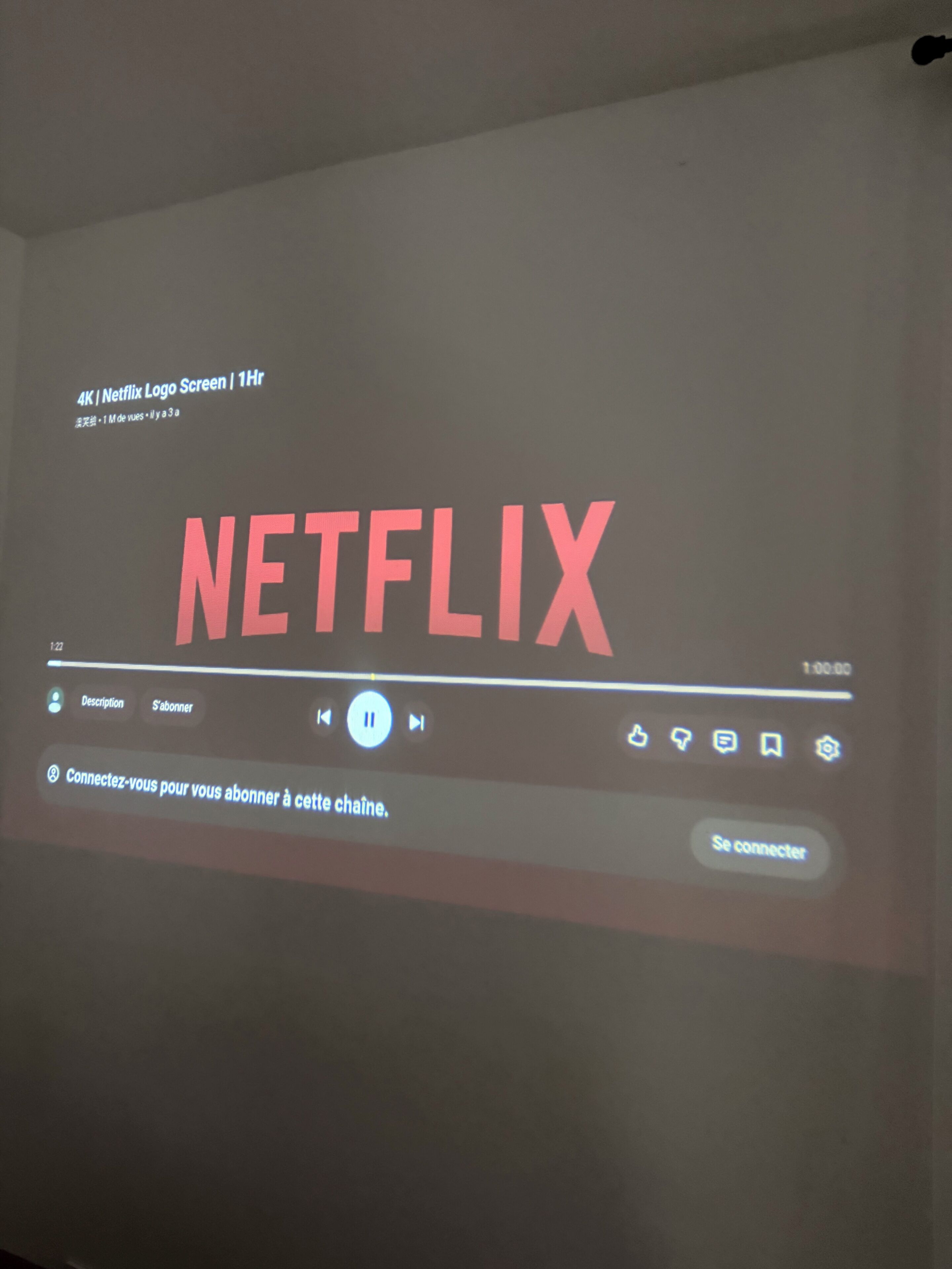 A Netflix interface on a screen with a progress bar and playback controls.