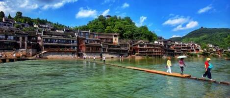 A riverside town with traditional buildings and clear water.