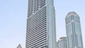 A tall, modern skyscraper with a glass facade and a distinctive, curved design at the top.