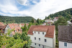 A residential area with traditional European architecture, including houses with sloped roofs and a church with a bell tower.