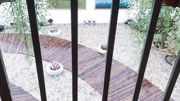 A wooden deck with planters and a gravel area.
