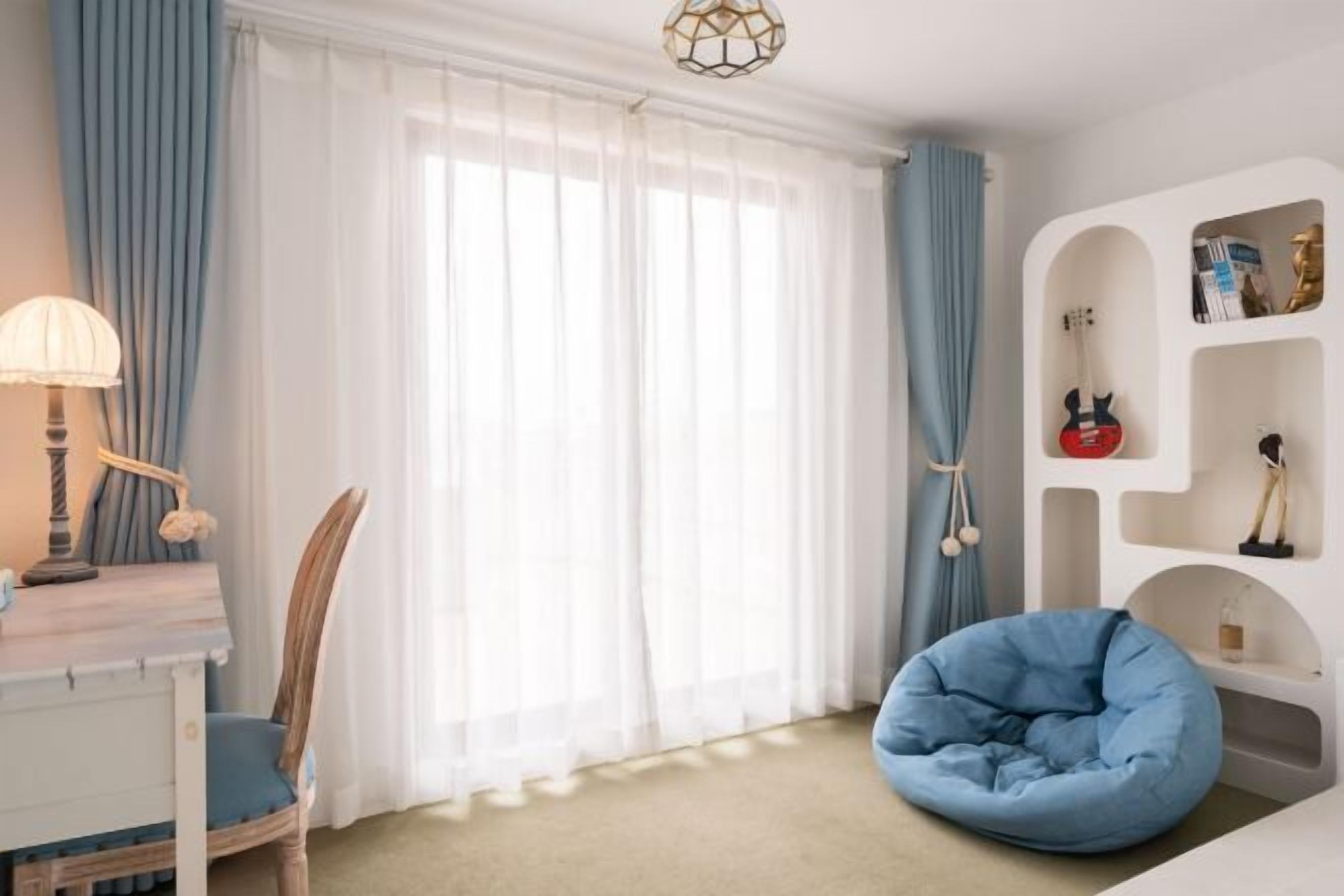 Una habitación con escritorio, silla, sillón de peluche azul y estantería con objetos decorativos.
