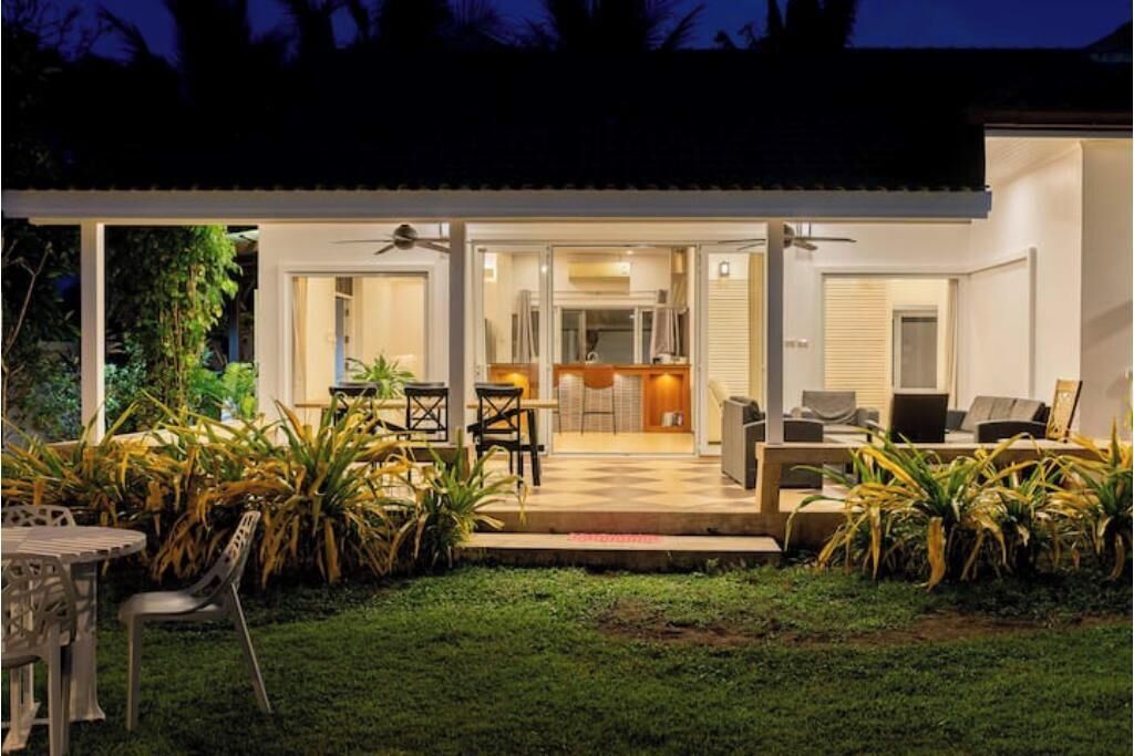 A modern house with an open-plan living area, a kitchen, and a dining space.