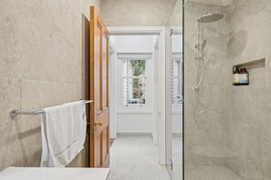 A bathroom with a glass shower enclosure, a white sink, and a towel rack. - Sandy Bay Style | Close to CBD (Sandy Bay)