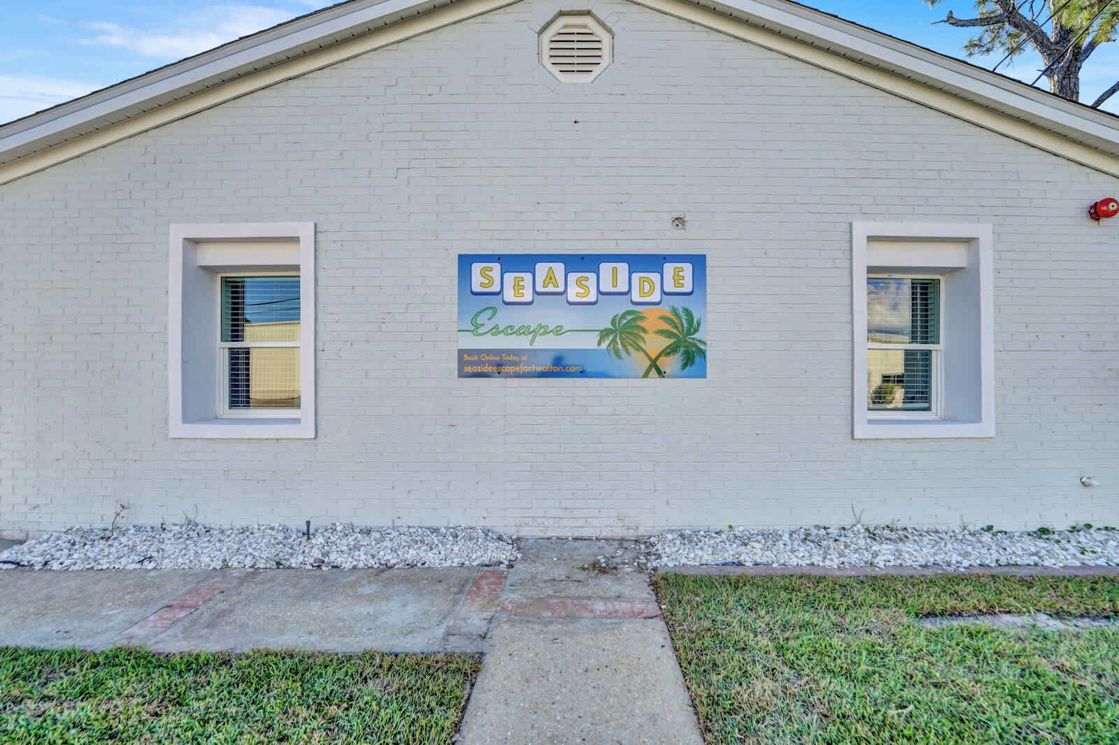 A building with a sign that reads 'SEASIDE Escape' and a website address.