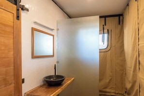 A compact bathroom with a wooden vanity, a mirror, and a shower curtain. - 2 bedrooms luxury glamping tent (Koh Samui)