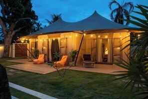 A tent-style accommodation with a covered patio, outdoor seating, and ambient lighting. - 2 bedrooms luxury glamping tent (Koh Samui)