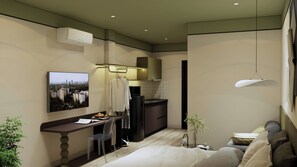 Una habitación de hotel moderna con escritorio, zona de estar, kitchenette y cama.