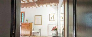 A room with a wooden cabinet, a framed certificate on the wall, and a chair. - Melchiade Uno Colonial House, a country cottage in the hills for 8 people, near Lucca (Borgo a Mozzano)