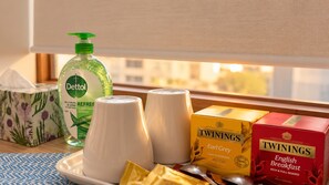 A breakfast tray with Twinings Earl Grey tea, Dettol hand sanitizer, and Twinings English Breakfast tea boxes.